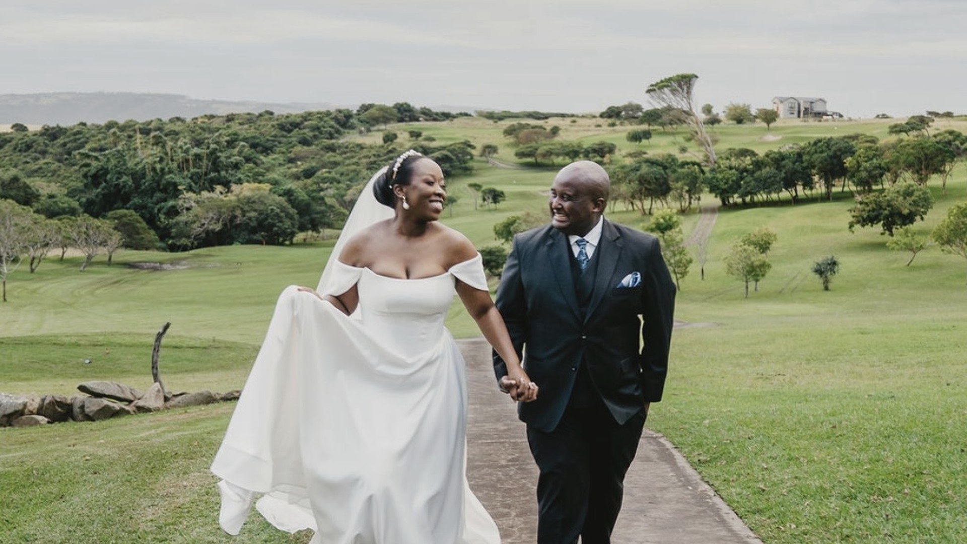 A bride and groom walking together outdoors